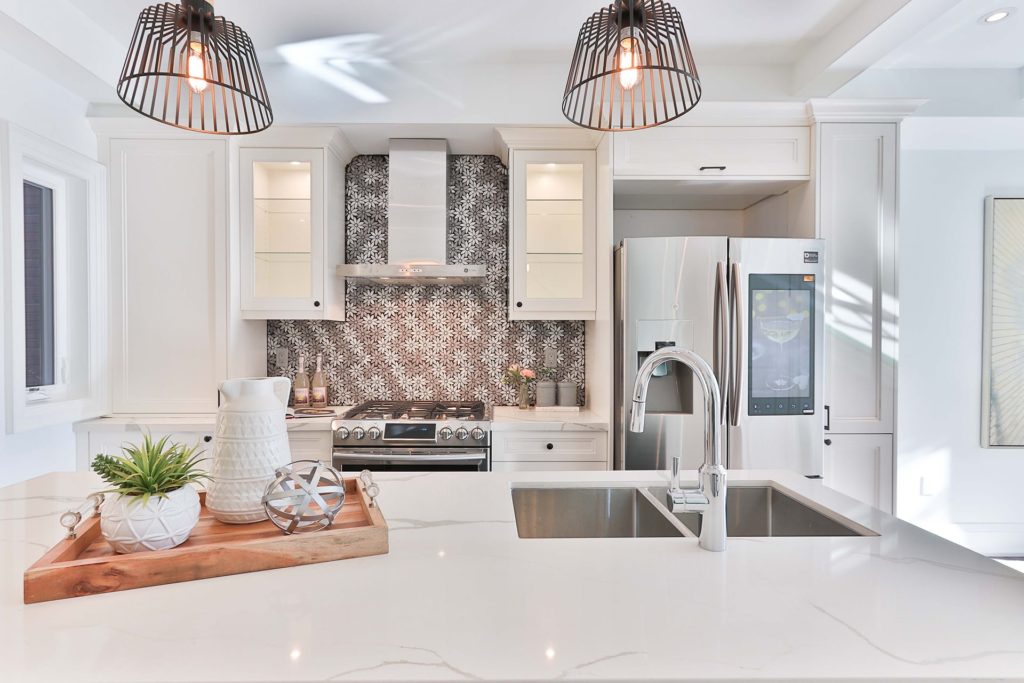 solid surface countertop with backsplash and stainless steel sink